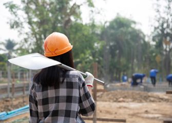 construction-workers-carrying-shovel-construction-site-min