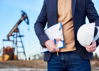 cropped-snapshot-inspector-oil-field-holding-folder-notes-helmet-min