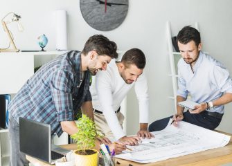 group-male-architect-preparing-blueprint-office-min